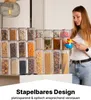 A woman is holding measuring cups and spoons in front of a large collection of clear food storage containers filled with various dry goods. Anteprima dell’immagine prodotto