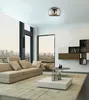 A modern living room with a large window overlooking a city skyline, featuring a sofa, coffee table, and a wall-mounted shelf unit. Produktbild-Vorschau