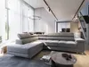 A modern living room with a large sectional sofa, coffee table, and a view of a dining area and kitchen. Produktbild-Vorschau