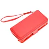 A red wallet with a wrist strap is shown against a white background. Produktbild-Vorschau