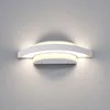 A modern white LED outdoor wall light mounted on a gray wall. Produktbild-Vorschau
