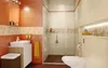 A modern bathroom with a shower, toilet, and sink. Podgląd zdjęcia produktu