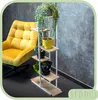 A yellow armchair and a multi-tiered plant stand with plants are placed in a room with a gray textured wall. Anteprima dell’immagine prodotto