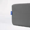 A close-up of a gray fitted sheet with a blue brand tag. Náhled obrázku produktu
