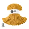A spool of mustard yellow cord on a white background. Podgląd zdjęcia produktu
