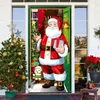 A festive Christmas door decoration featuring Santa Claus, a Christmas tree, and a small dog, set against a house entrance. Produktbild-Vorschau