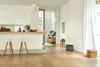 A modern kitchen and living area with wooden floors and white walls. Náhled obrázku produktu