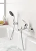A bathtub with running water and a showerhead. Produktbild-Vorschau