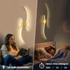 A split image showing a woman reading on a couch under a wall lamp and a child sleeping in bed with a wall lamp above. The wall lamp is the product. Voir les images du produit