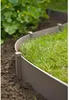 A close-up shot of garden edging separating a lawn from a garden bed. Produktbild-Vorschau