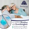 An elderly couple in bed, looking at each other affectionately. A close-up inset shows a product feature with blue liquid being absorbed. Produktbild-Vorschau