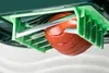 A close-up view of a tomato being sliced by a kitchen gadget with multiple blades. Produktbild-Vorschau