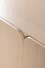 A close-up shot of the corner of a wooden cabinet with a curved edge. Produktbild-Vorschau