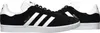A pair of black Adidas Gazelle sneakers with white stripes and soles, shown from a side view against a white background. Produktbild-Vorschau