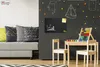 A child's play area with a chalkboard wall, a small table and chairs, and a couch. Podgląd zdjęcia produktu