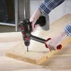 A person is using a cordless drill to drill a hole in a wooden plank. Produktbild-Vorschau
