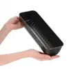 Hands holding a black loaf pan. Podgląd zdjęcia produktu