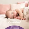 A baby sleeping on a bed with pillows in the background. Produktbild-Vorschau