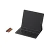 A black tablet with a keyboard cover and a brown accessory are placed on a white background. Anteprima dell’immagine prodotto