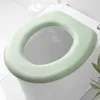 A close-up view of a light green toilet seat cushion placed on a white toilet. Podgląd zdjęcia produktu