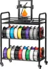 A black three-tiered rolling cart filled with spools of 3D printer filament, with a 3D printer on the top shelf printing an orange object. Podgląd zdjęcia produktu