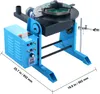 A blue and black welding positioner with a rotating table and control box is shown in a studio setting. Podgląd zdjęcia produktu