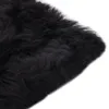 A close-up view of a black sheepskin rug. Podgląd zdjęcia produktu