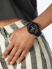 A person wearing a black G-Shock watch on their wrist, with their hand in their pocket. Voir les images du produit