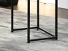 The legs and base of a black metal console table are shown on a grey patterned rug. Anteprima dell’immagine prodotto