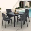 A black square table and four chairs are set up on a patio next to a swimming pool. Produktbild-Vorschau