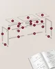 An exploded view diagram showing the assembly of a table, with labeled parts, accompanied by an open instruction manual. Náhled obrázku produktu