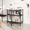 A round dining table with two shelves, styled with books and decorative items, set against a white wall. Podgląd zdjęcia produktu