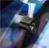 A dash cam is mounted on a car windshield with water droplets on the glass. Produktbild-Vorschau