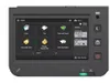 A close-up of a multifunction printer's touchscreen interface, displaying various options like Copy, Fax, and Scan and Send. Produktbild-Vorschau