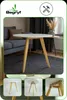A round white coffee table with wooden legs is shown in a living room setting, with additional close-up shots of the table's construction. Podgląd zdjęcia produktu