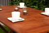A wooden garden table set for coffee with cups and candles. Produktbild-Vorschau