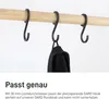 Close-up of three black S-hooks hanging on a wooden rod. One hook has a black piece of fabric hanging from it. Produktbild-Vorschau