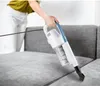 A person is using a handheld vacuum cleaner to clean a sofa. Náhled obrázku produktu