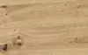 A close-up view of a wooden surface with visible grain and knots. Produktbild-Vorschau