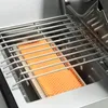 A close-up view of a gas grill's heating element and grate. Produktbild-Vorschau