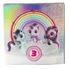 The image shows the packaging for a toy, featuring three unicorn figures on a cloud with a rainbow in the background. The packaging has colorful, holographic elements and text. Podgląd zdjęcia produktu