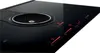 A close-up, angled view of a black induction cooktop with an integrated ventilation system. Náhled obrázku produktu