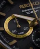 A close-up shot of a black and gold Seiko chronograph watch face. Náhled obrázku produktu