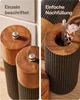A split image showing two close-up views of wooden salt and pepper grinders. The left side shows two grinders labeled 'S' and 'P'. The right side shows a grinder being refilled with salt. Produktbild-Vorschau