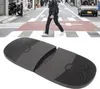A person walking across a street crossing, with a close-up of shoe heel protectors below. Voir les images du produit