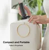 A person is placing a portable electric air duster into a white handbag. Náhled obrázku produktu