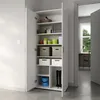 A white multi-purpose cabinet with its doors open, revealing shelves filled with various storage items like boxes, baskets, and containers. The cabinet is positioned in a room with a doorway visible in the background, leading to another room with a desk an Voir les images du produit