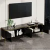 A black TV cabinet with gold accents and legs, shown with its doors open, displaying books and decorative items. A television is mounted on the wall above it. Anteprima dell’immagine prodotto