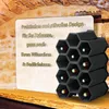 A black modular wine rack filled with bottles, placed on a wooden shelf in front of a stone wall background. A light-colored rectangular panel with German text is to the left of the wine rack. Produktbild-Vorschau