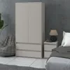 A bedroom scene featuring a wardrobe, nightstand, lamp, and bed. Produktbild-Vorschau